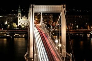 A long exposure photo of a bridge at night