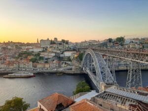 a bridge over a river with a city in the background