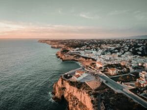 an aerial view of a city next to the ocean