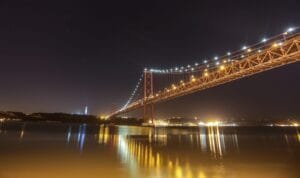a large bridge over a body of water at night